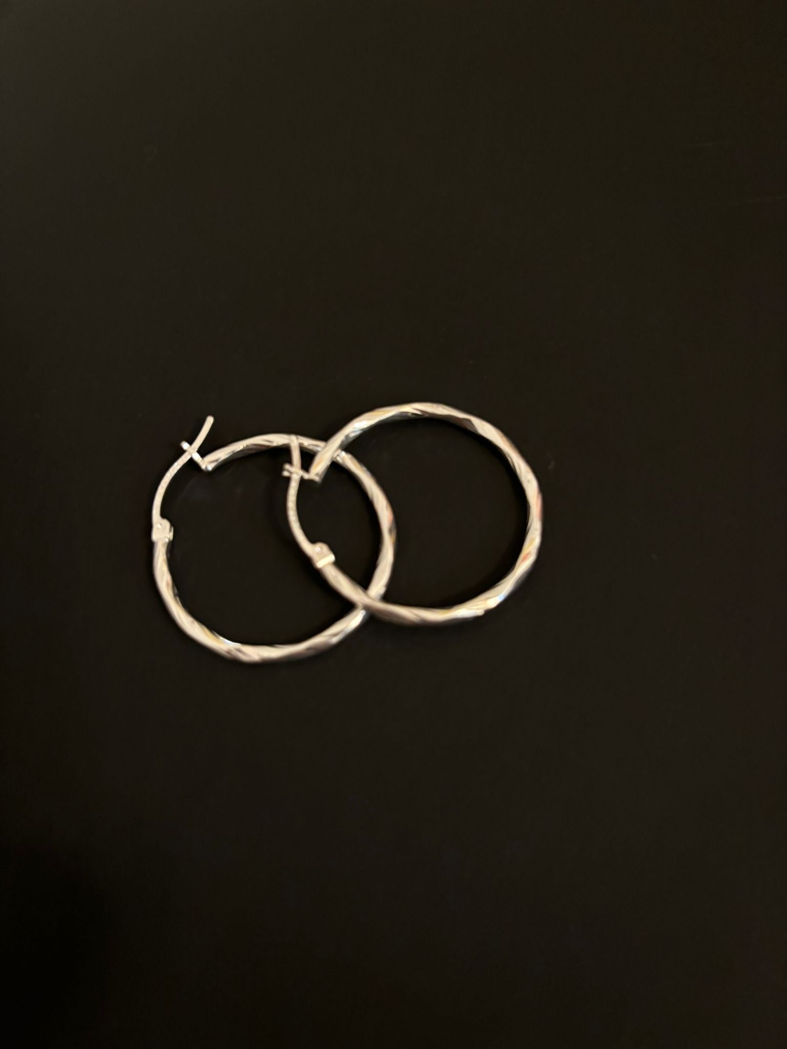 Silver hoop earrings with a diamond-cut design